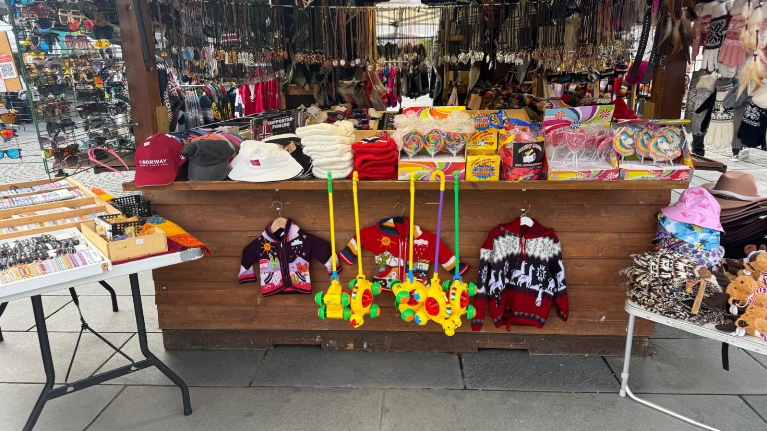 Colourful POPOL VUH market display with hats and accessories